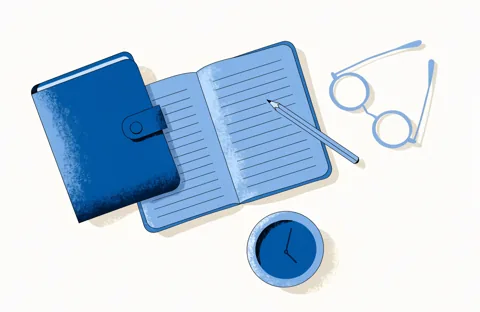 Top-down view of a desk with a closed folder, an open notebook with a pencil, a pair of glasses and a small clock.
