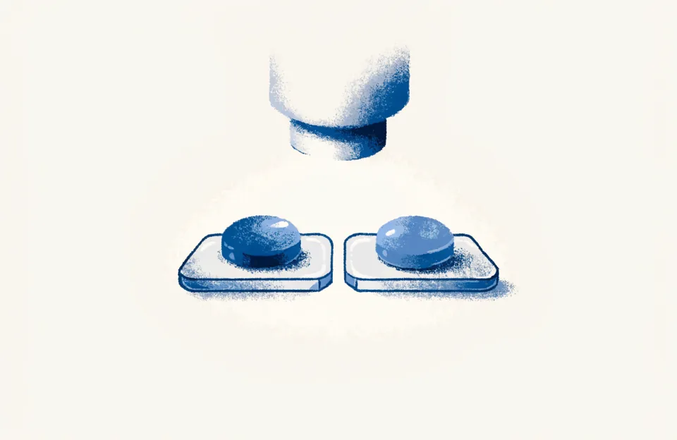 Two laboratory slides with a blue sample each, under the light of a microscope.